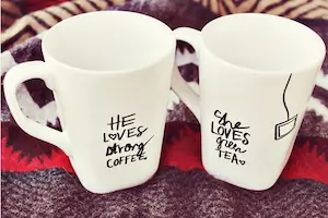 two coffee mugs with sharpie text