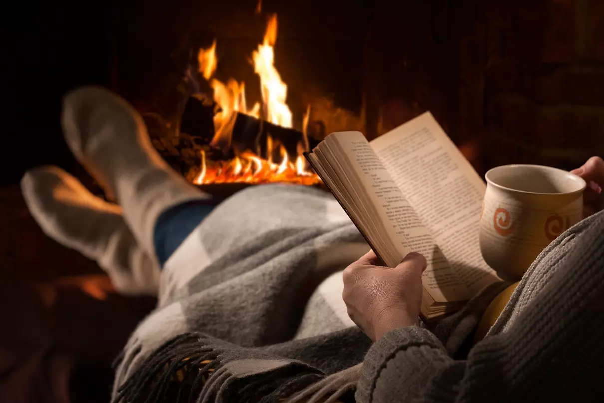 Tenant relaxing by fireplace