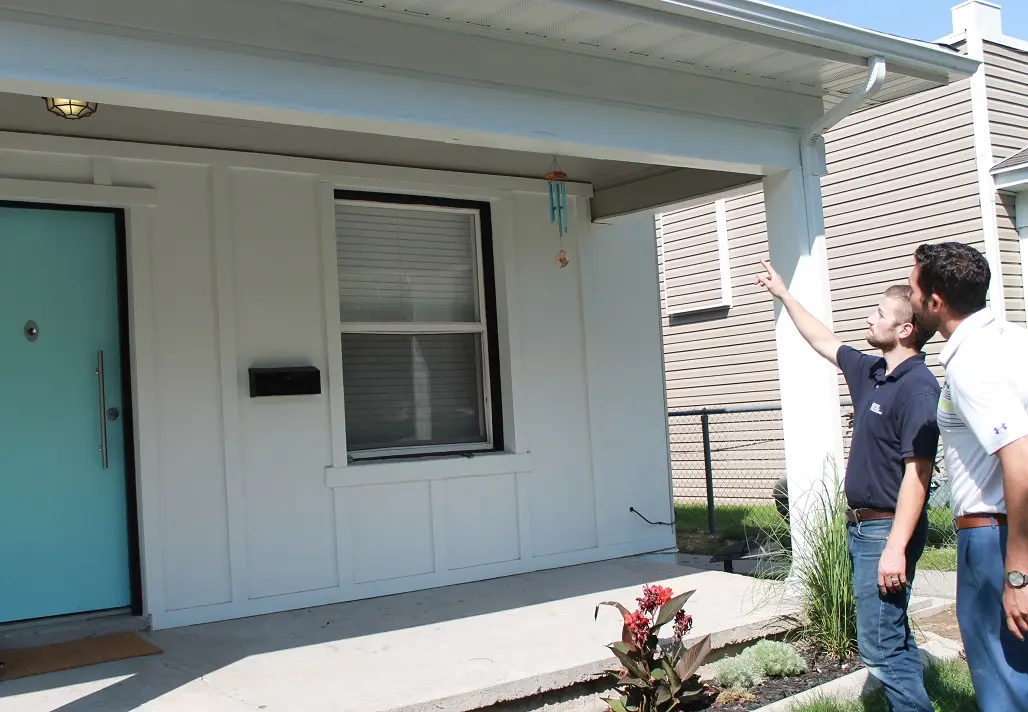 Property manager pointing at house