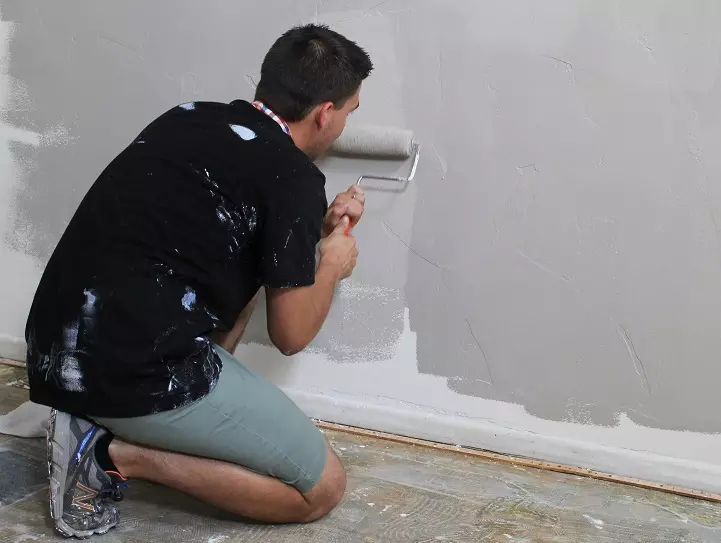Male tenant painting a wall