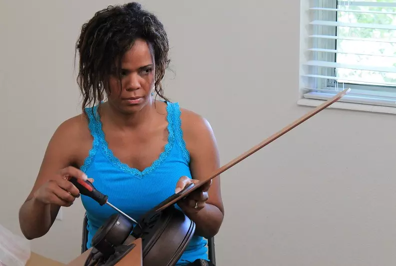 Woman trying to fix ceiling fan