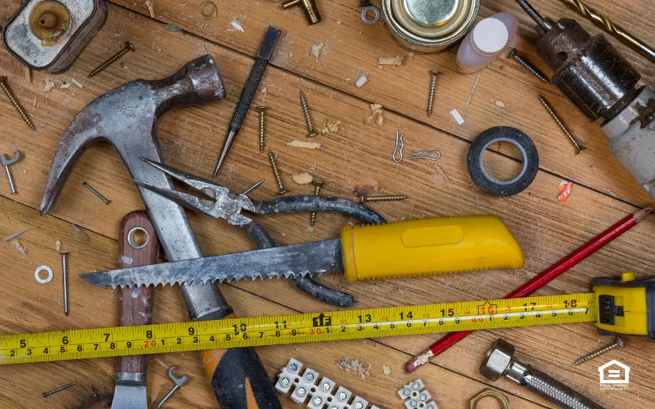 Home maintenance tools lying on a wood floor