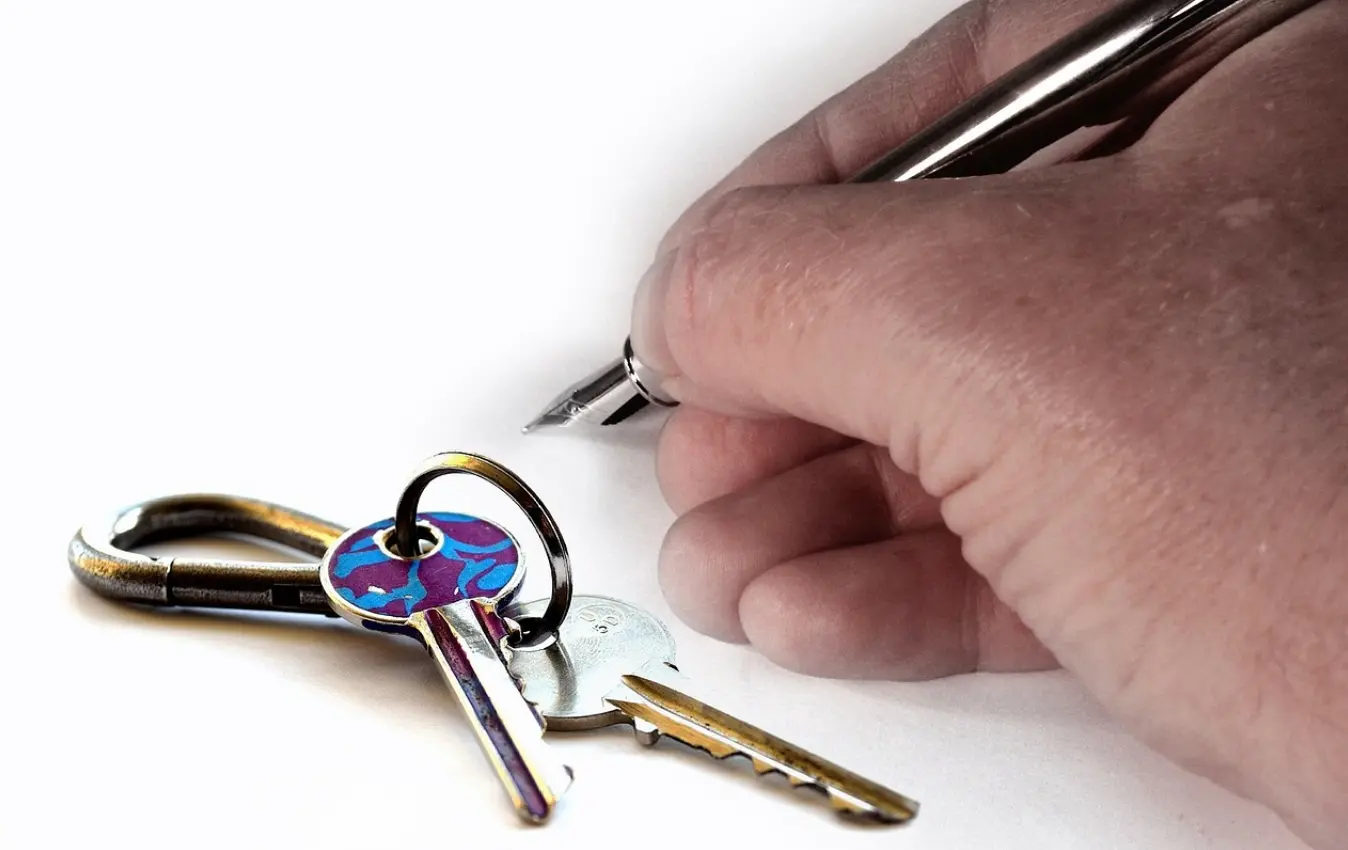 Keys next to hand writing with a pen
