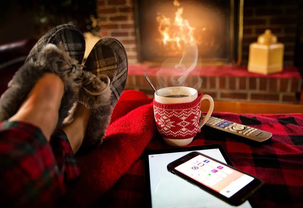 Picture of person's feet by fireplace