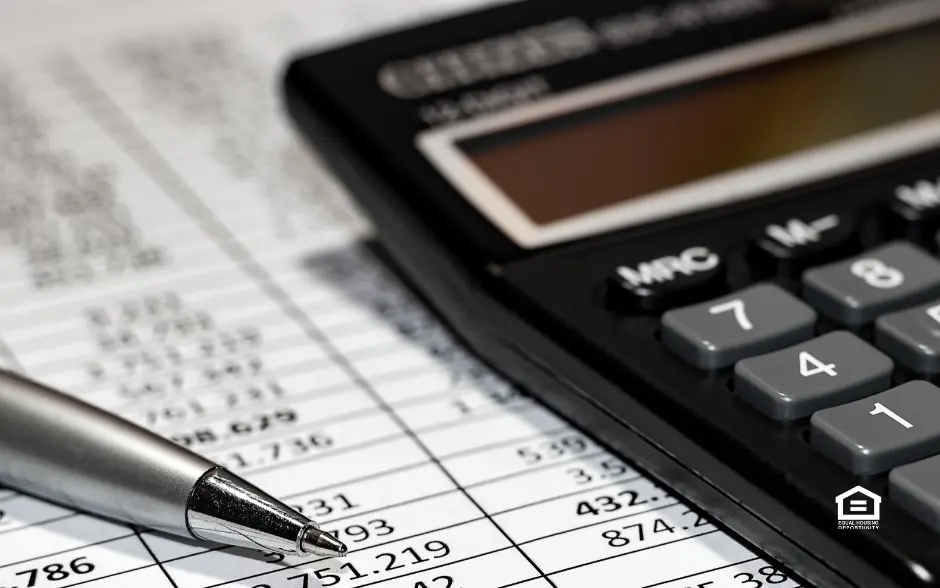 Close up of accounting records, pen, and calculator