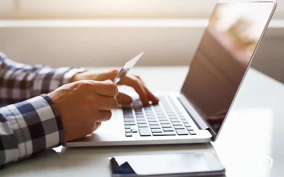 Close up of man's hands with credit card and laptop computer