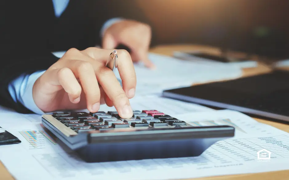 Close up of CPA hands with a calculator and papers