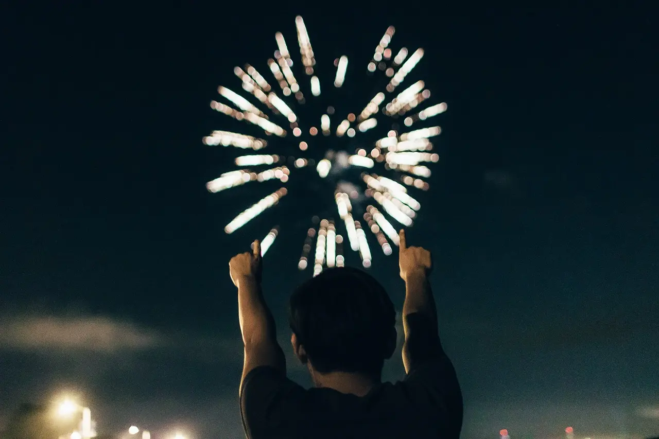 Man in front of fireworks