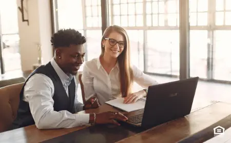 man and woman looking at a computer