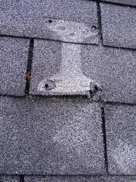 Roof damage from a mounted satellite dish.