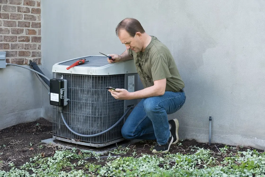 Man repairing AC unit