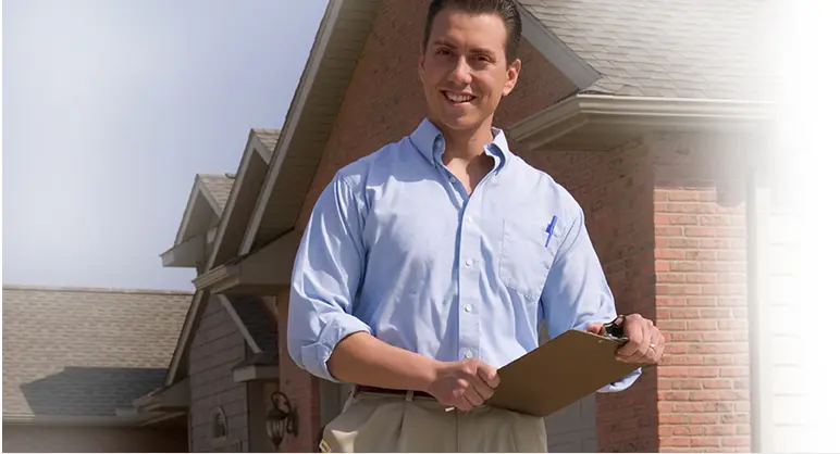 Smiling man holding a clipboard.